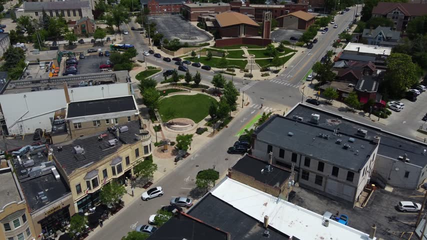 Slow Approach Aerial Village of Wauwatosa Wisconsin in the Milwaukee region. Restaurants on the river.	