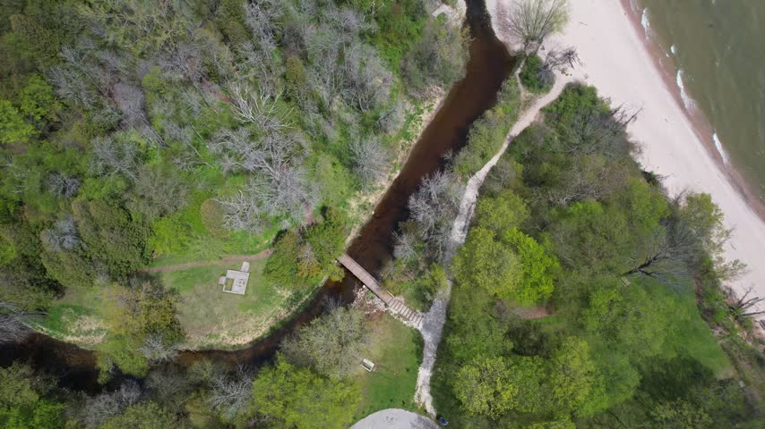 
Descending Park Bridge Aerial of Silver Creek Park in Manitowoc Wisconsin on the Shore of Lake Michigan