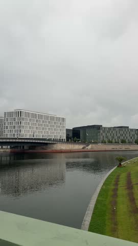 Berlin city downtown modern buildings on Spree river bank panoramic view on a moody cloudy day. Contemporary Berlin architecture