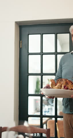Turkey, thanksgiving and old man with family at table for festive season, food and celebration. Holiday, nutrition and lunch gathering with people in dining room in home for serve, party and meal