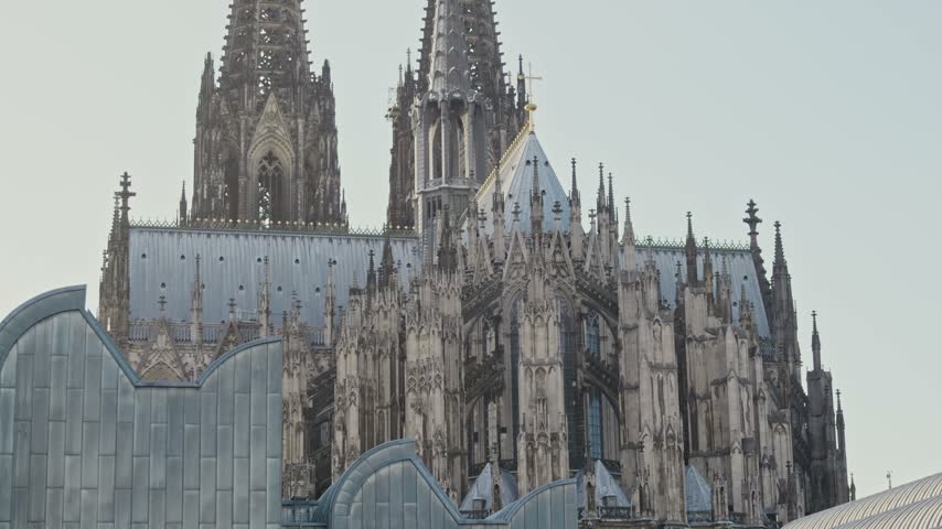 Gothic spires and architectural details of Cologne Cathedral against clear sky in Cologne, Germany