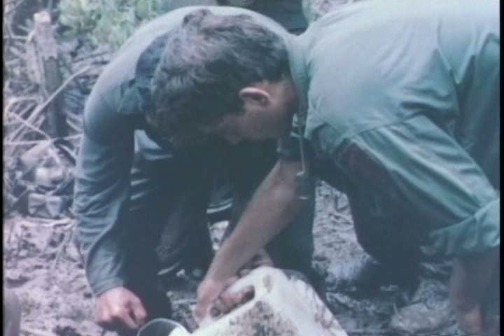 1960s - A group of soldiers search for Vietcong troops during the Vietnam War