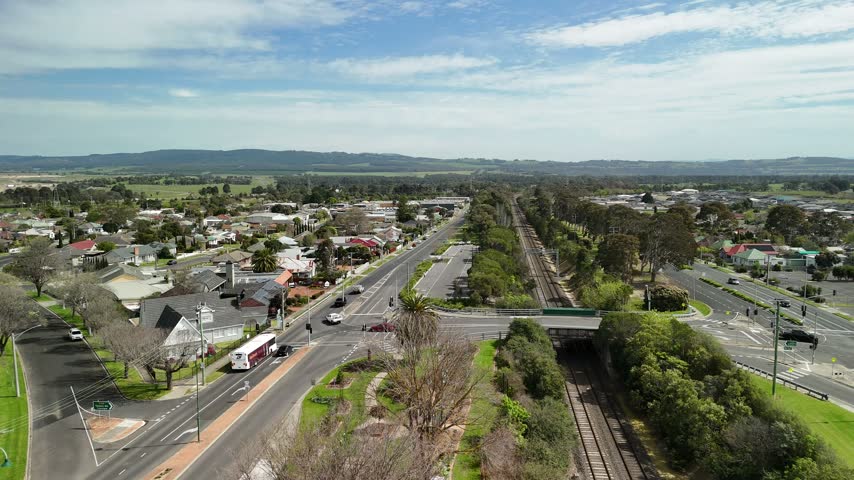 Morwell, Victoria, Australia – 4K aerial drone view of Latrobe Valley regional city, traffic, shops and houses, divided roads, railway corridor, residential neighbourhoods and urban infrastructure