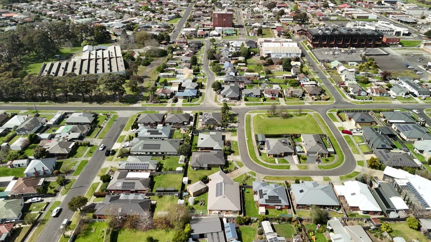 Morwell, Victoria, Australia – 4K aerial drone view of Latrobe Valley regional city, traffic, shops and houses, divided roads, railway corridor, residential neighbourhoods and urban infrastructure
