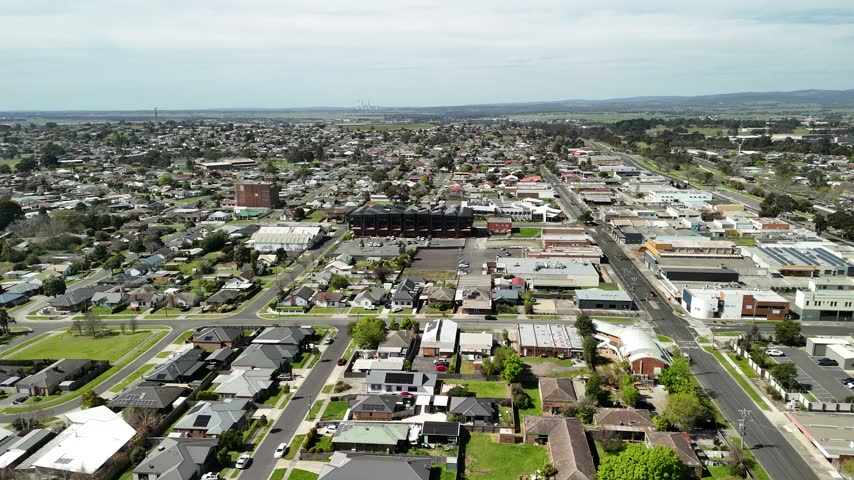 Morwell, Victoria, Australia – 4K aerial drone view of Latrobe Valley regional city, traffic, shops and houses, divided roads, railway corridor, residential neighbourhoods and urban infrastructure