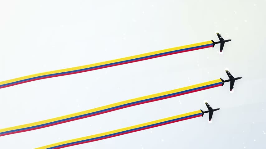 Three jet fighter planes flying in formation during an airshow leaving colorful yellow blue and red smoke trails in clear sky