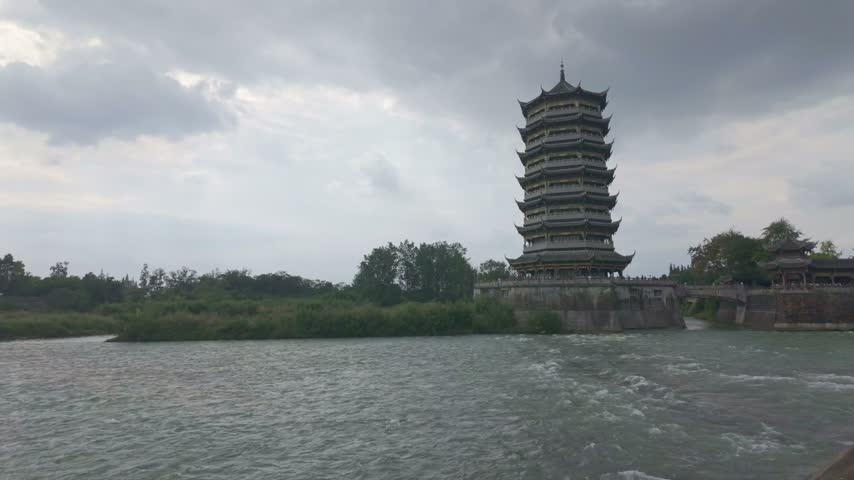 The ancient architectural pagoda on the turbulent river
