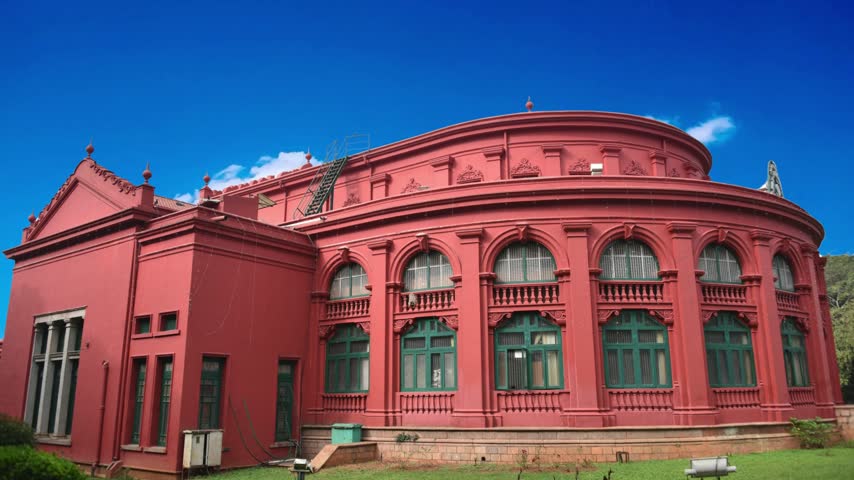 State Central Library, Bangalore,Karnataka, IndiaBangalore, India  State Central Library in Bangalore, India . Colonial architecture building of the State Central  in Bangalore is one of the largest in India. Historic library housed in a striking red building with a unique round room, on the edge of a Cubbon park, Bangalore city, Karnataka state. This photo was captured 