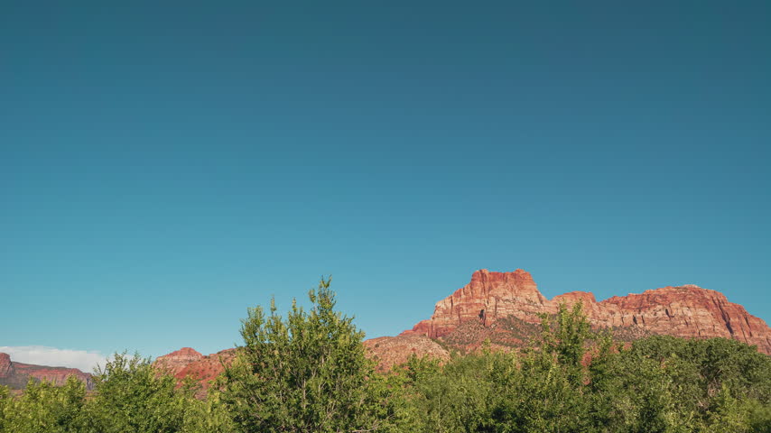 Time-lapse of clouds moving over red rock cliffs in Zion National Park, Utah.
