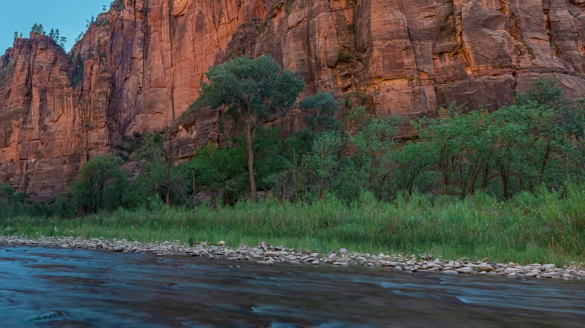 Time-lapse of towering red rock cliffs in Zion Canyon, Utah.