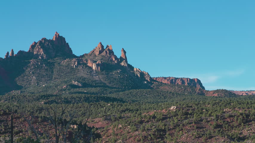 Time-lapse of sunset over red rock cliffs in Zion National Park, Utah.