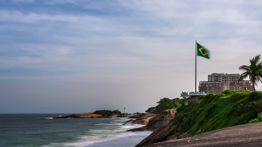 Timelapse from the coastline near Forte de Copacabana in Rio de Janeiro, Brazil with a giant Brazilian flag