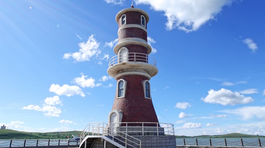The retro lighthouse at the end of the lakeside walkway