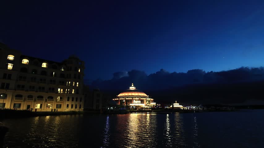 Mongolian-style buildings seen from the lake shore at dusk in the blues