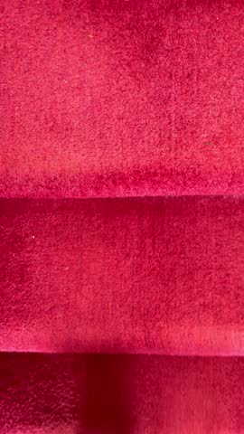 Vertical video – Closeup of a man wearing black shoes, climbing a pink carpeted staircase inside a home.