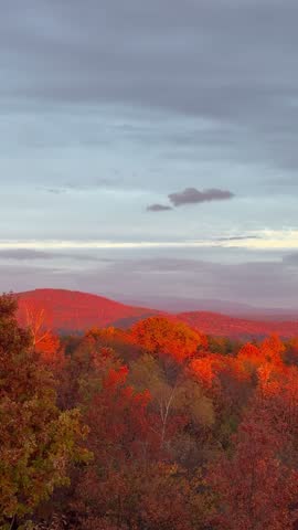 A view of a small mountain town in the light of the setting sun.
