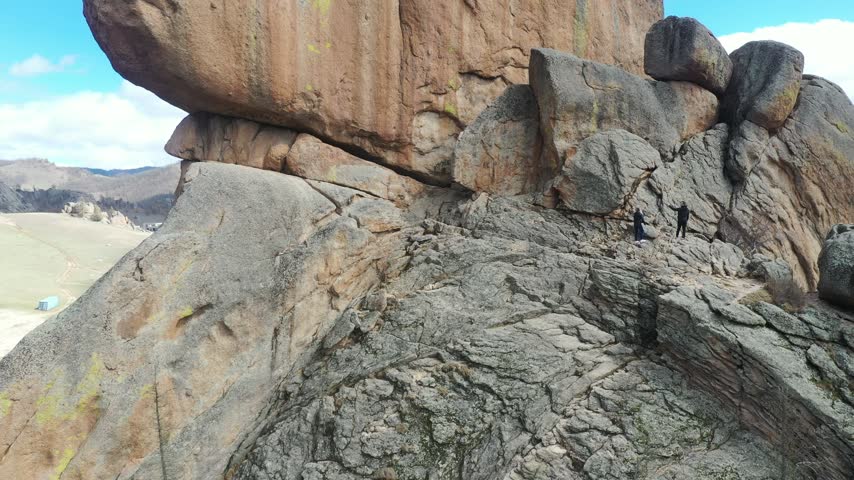 Couple Climbing a Rocky Mountain During an Outdoor Adventure