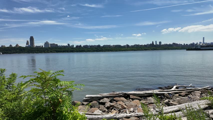 Manhattan seen across the Hudson River from a New Jersey riverside walkway