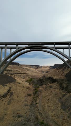 Arched Bridge Over Desert Canyon