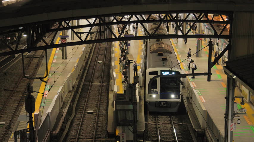 Night in Tokyo  :  Outbound Commuter Train Departing the Terminal, Viewed from Above  |  Ikebukuro Station, Tokyo, Japan
