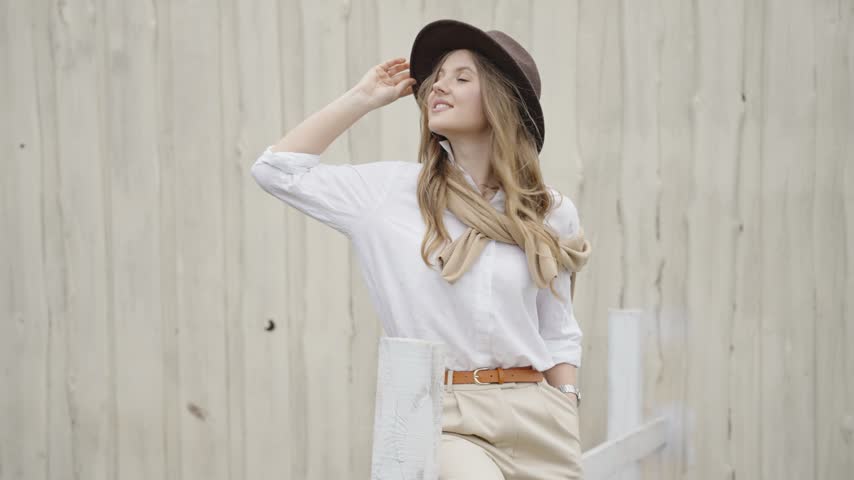 Beautiful young woman posing with a fedora hat