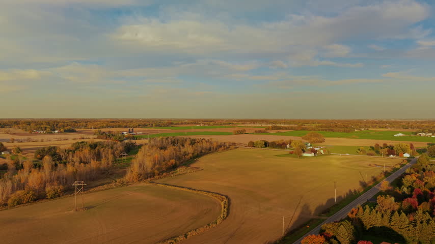 Rising Aerial Establishing Shot of Vast Rural Wisconsin Farmland with Houses During Colorful Autumn Day