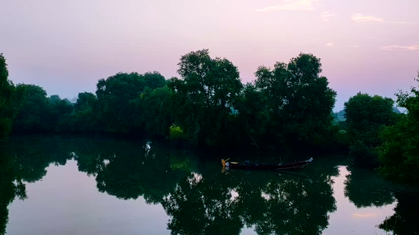 sunrise at the river with boat in the river.