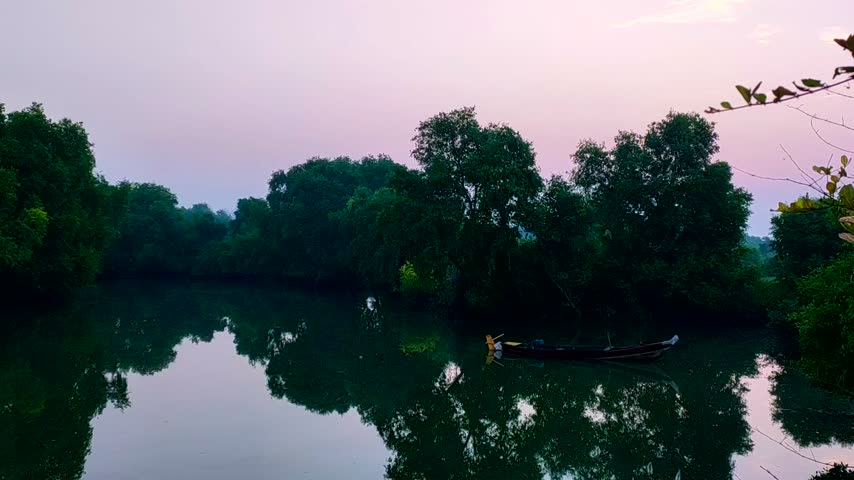 sunrise at the river with boat in the river.