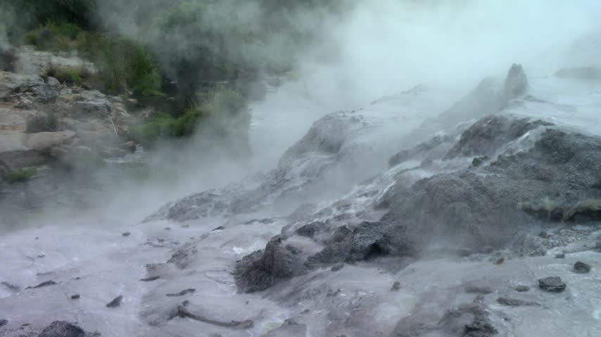 Hot Water Flowing Over Geothermal Rocks with Massive Steam at Pohutu Geyser, Rotorua in Whakarewarewa Thermal Valley, Rotorua, New Zealand. Static shot