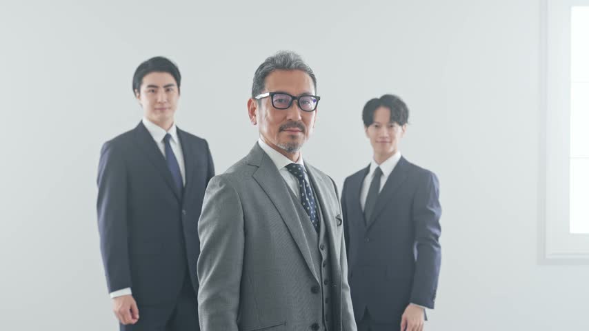 A group of male business people making a victory pose.