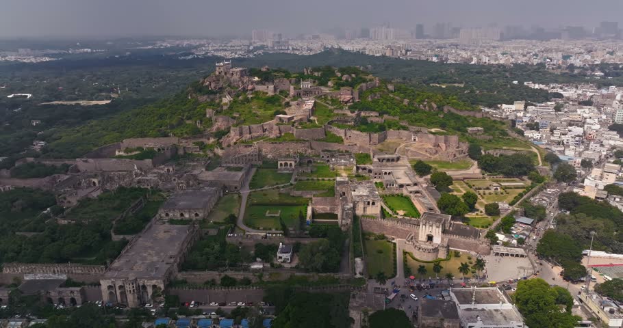 Aerial drone view of the historic Golconda Fort in Hyderabad, Telangana, India, showcasing its impressive stone fortifications, ancient architectural structures, and sprawling historic complex.