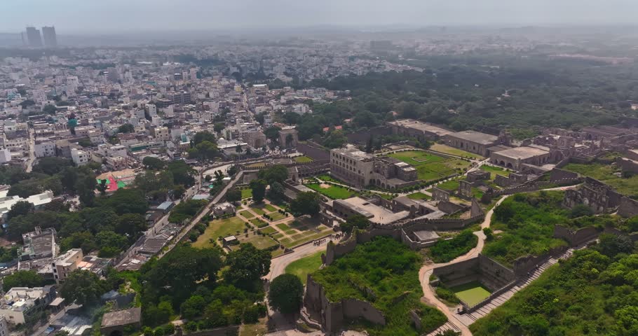 Aerial drone view of the historic Golconda Fort in Hyderabad, Telangana, India, showcasing its impressive stone fortifications, ancient architectural structures, and sprawling historic complex.