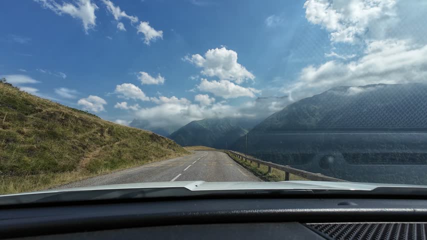 Car driving on a scenic mountain road in Superbagneres, Pyrenees, with a view from the dashboard