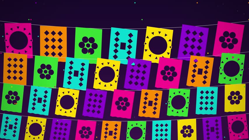 Colorful traditional Mexican papel picado banners with intricate cut out floral and geometric designs hanging on strings against a dark background.