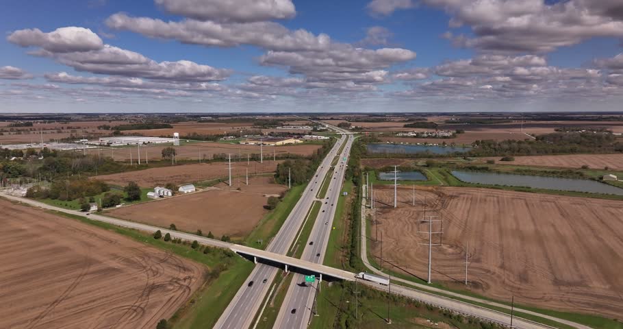 Aerial view of a highway stretching through rural fields with power lines and an overpass in Washington Court House, Ohio, United States.