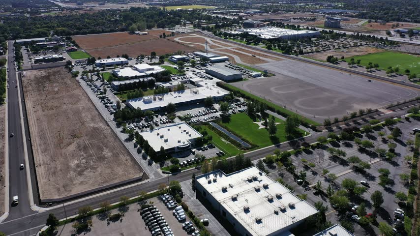 High aerial drone view of a business park, warehouses and parking lots in Meridian, Idaho on a clear morning.