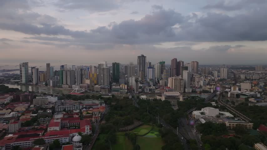 Aerial push in over Manila, Philippines: dusk skyline with animated statistic counter, 14,001,751 metro residents, on frosted glass card, VFX infographic, copy space. Concept of megacity, census