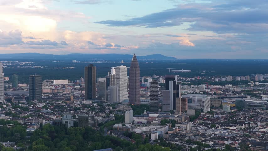 Aerial skyline of Frankfurt, Germany: towers in evening light with animated statistic counter, 754,896 residents, on frosted glass card, VFX infographic, copy space. Concept of demographics, census