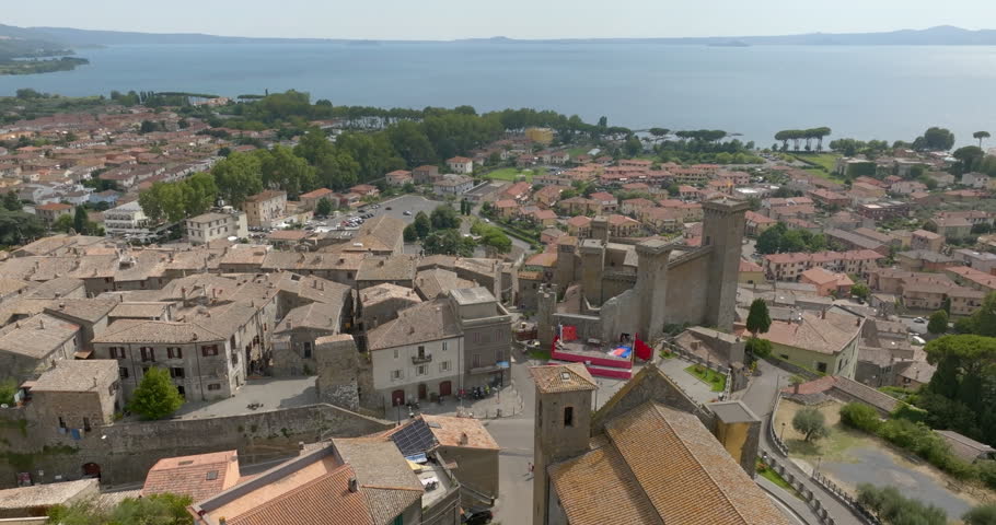 Panoramic view of Bolsena from above, with the historic center in the foreground, the medieval castle, the modern town and Lake Bolsena on the horizon, in the province of Viterbo, in Lazio, Italy.