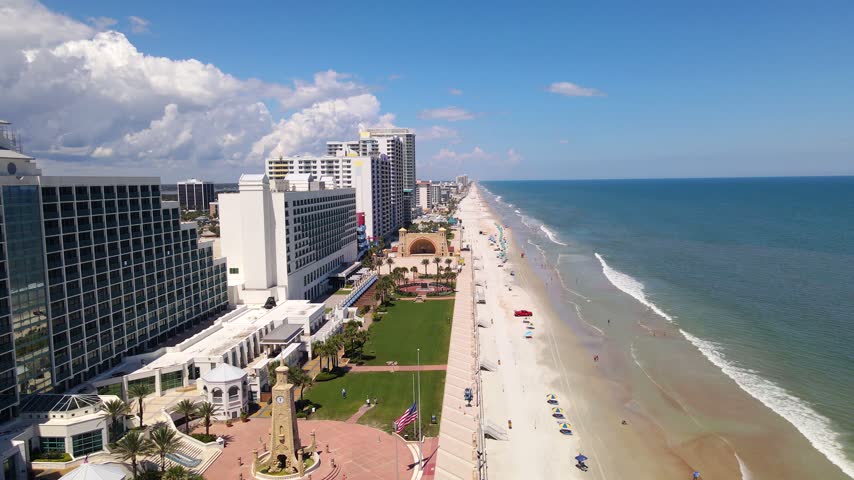 A waterfront plaza opens between beachfront architecture and the Daytona Beach shoreline.