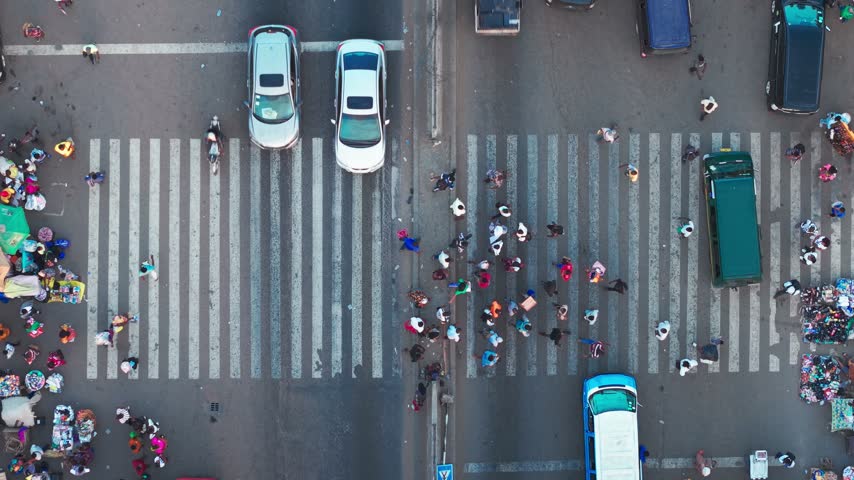 Aerial view showing local Kaneshie market with pedestrians, vehicles, and street vendors