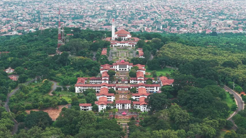 Aerial view of University of Ghana campus building on a hill with a sprawling Accra city in the background