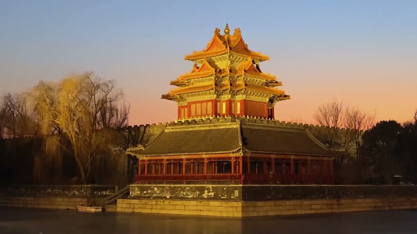 The forbidden city at sunset in Beijing,China. Corner Tower by the Lake of the Forbidden City.