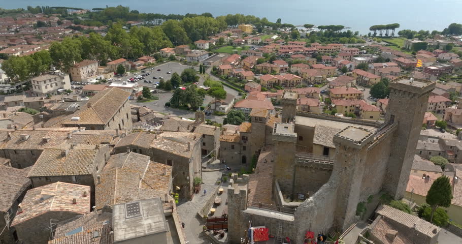 Aerial view of the historic center of Bolsena with the towers of the Monaldeschi Castle and the lower town reaching Lake Bolsena, in the province of Viterbo, in Lazio, Italy. It