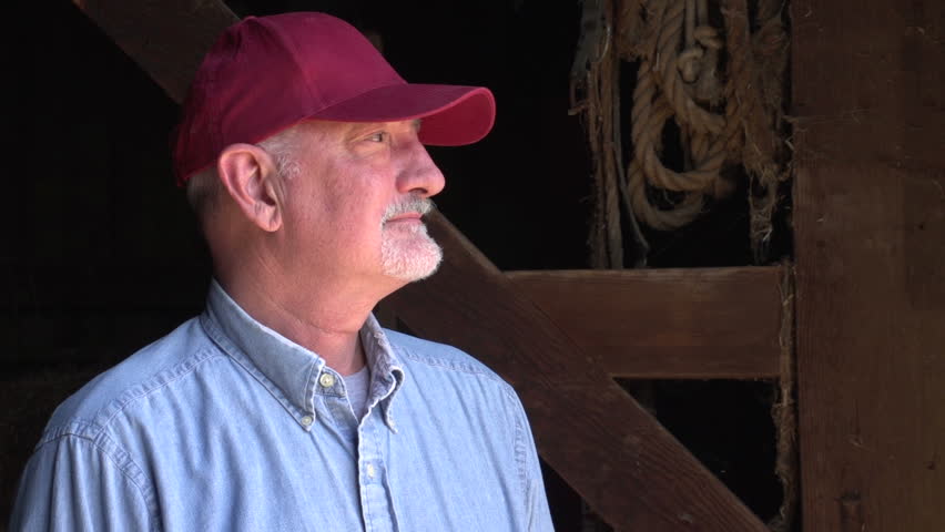 Farmer standing in a barn