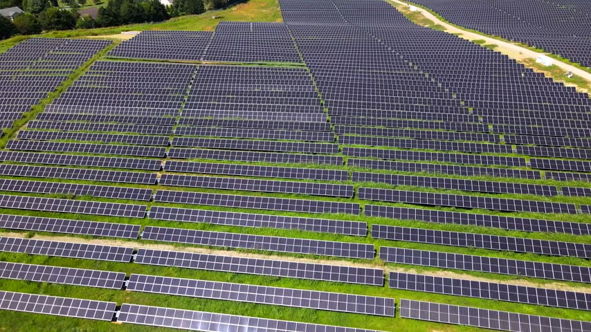 Sunlight reflects across parallel solar panels during an aerial flight in Virginia.