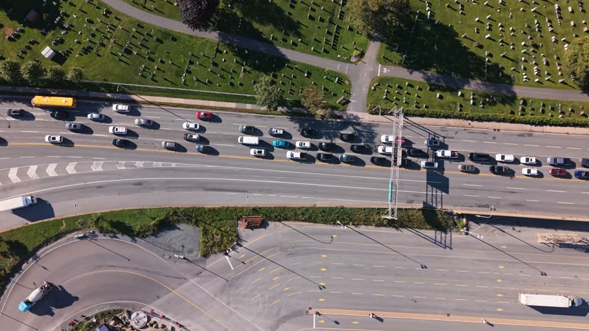 From above, the lively streets of Halifax, Nova Scotia reveal a bustling urban scene filled with cars and people. Green parks offer a calming contrast, showcasing the city