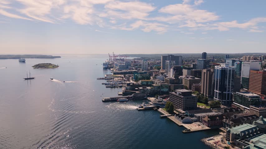 Experience the stunning aerial view of Halifax, Nova Scotia, where city life gracefully meets its beautiful waterfront. Enjoy the vibrant skyline and serene waters in harmony.