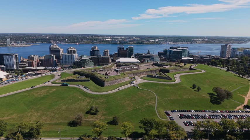 Explore the stunning aerial perspective of Halifax, Nova Scotia, revealing lush green parks, historic sites, and the sparkling waterfront. The vibrant city blends nature with urban charm effortlessly.