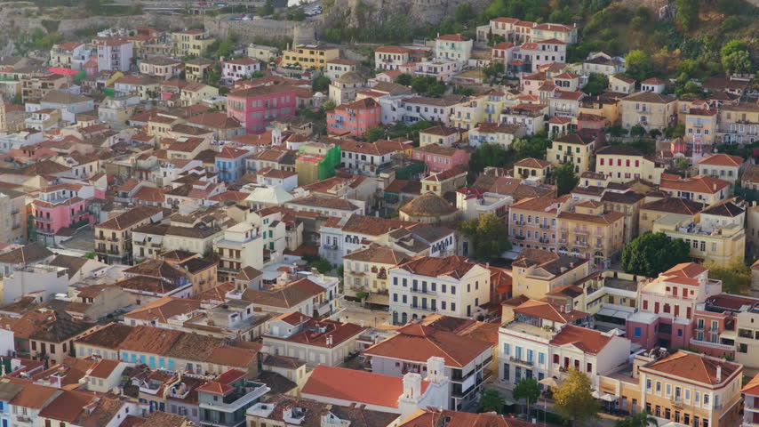 Aerial perspective revealing the dense urban landscape of Nafplio. Greece. Showcasing its colorful neoclassical buildings and traditional red-tiled roofs nestled together in the historic city center